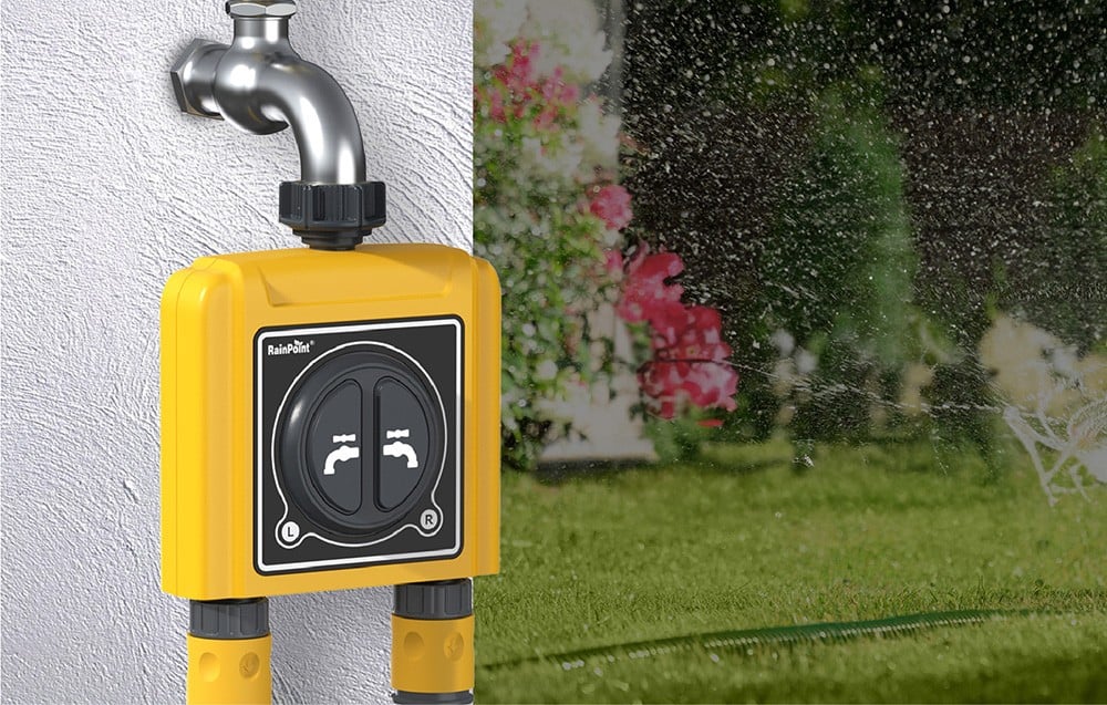 RainPoint irrigation controller mounted to a white plaster wall, with the garden in the background.