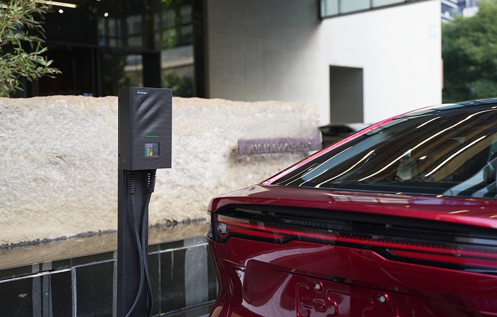 Red car charging with an EV charger