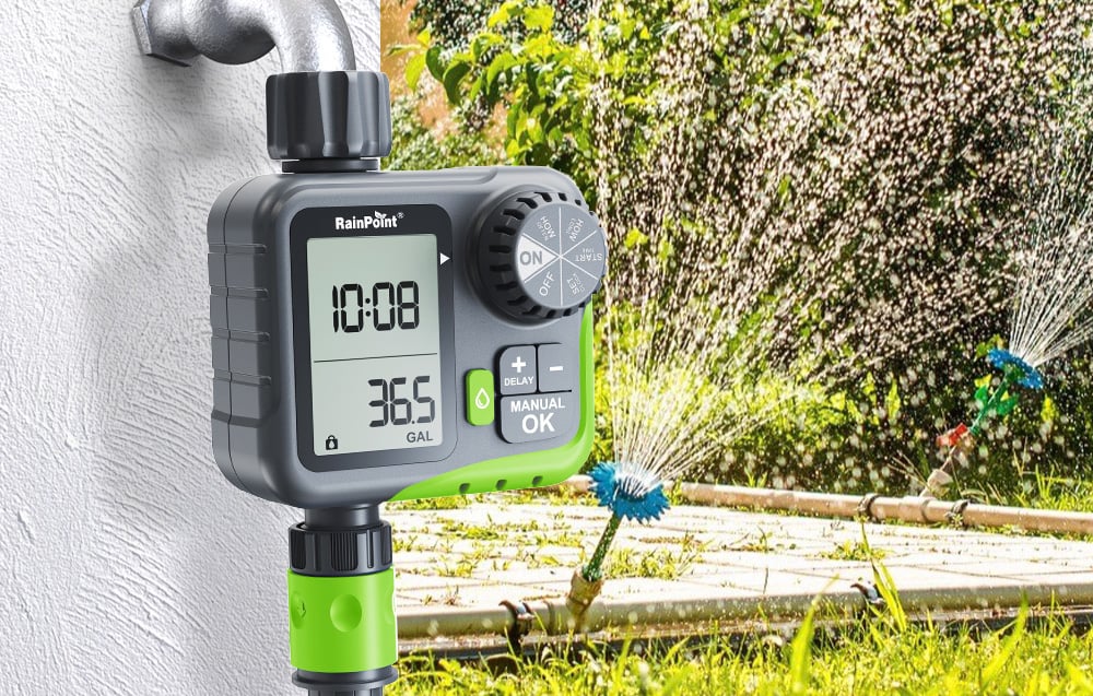 Irrigation controller mounted on a faucet, operating a rotating sprinkler system on the lawn in front of the house