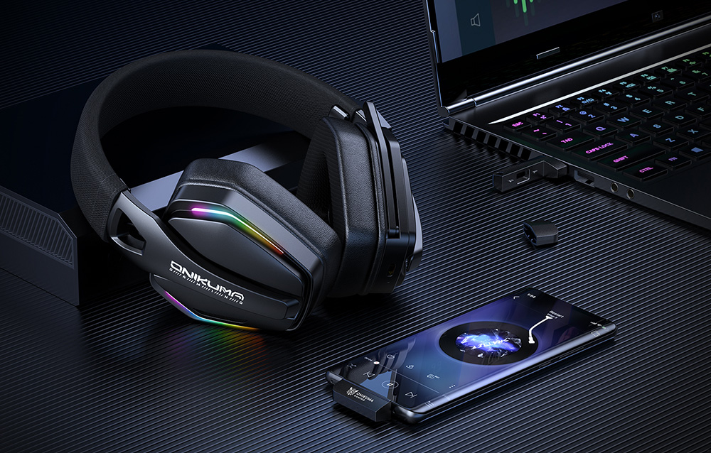 In-ear headphones lying on black table next to smartphone and laptop