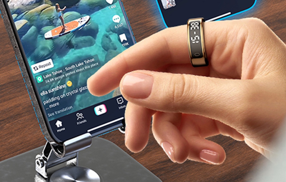 Smartphone on silver stand and hand with smartring.