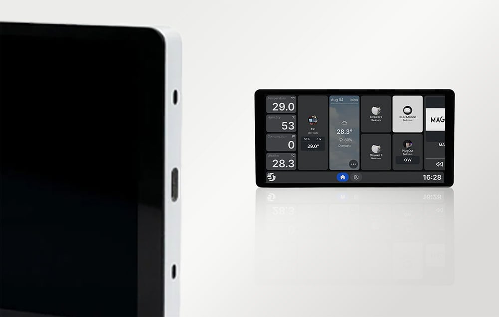 Close-up of the silver edge of the Shelly X2i panel with the USB-C port and sensors visible, with a second panel visible in the background.