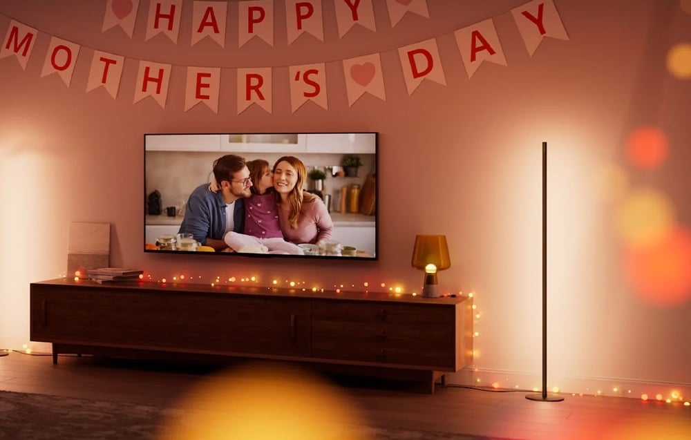 Cozy living room with TV, light garland and banner