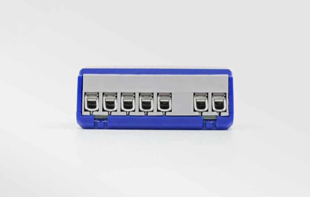 Front view of a row of metal screw terminals in the blue module