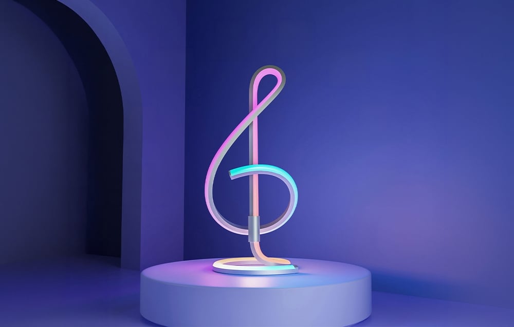 A desk lamp shaped like a treble clef, emitting neon light on a round pedestal in a blue room.