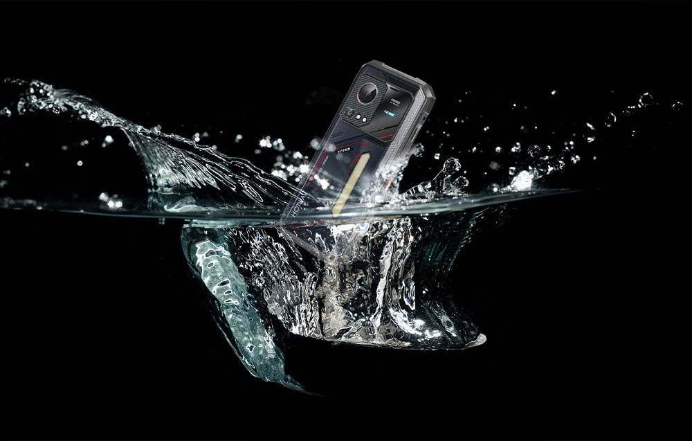 A HOTWAV smartphone falling into water with dynamic splashes, illustrating its water resistance.