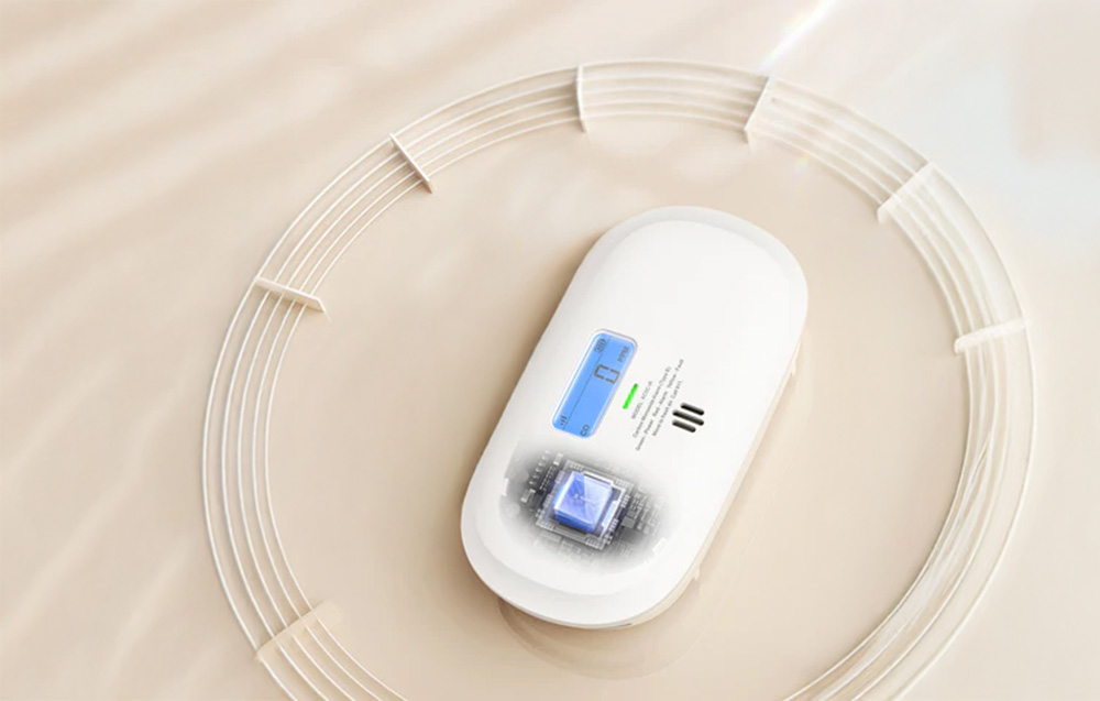 Carbon monoxide detector lying on a bright background with a graphic symbol of a microprocessor