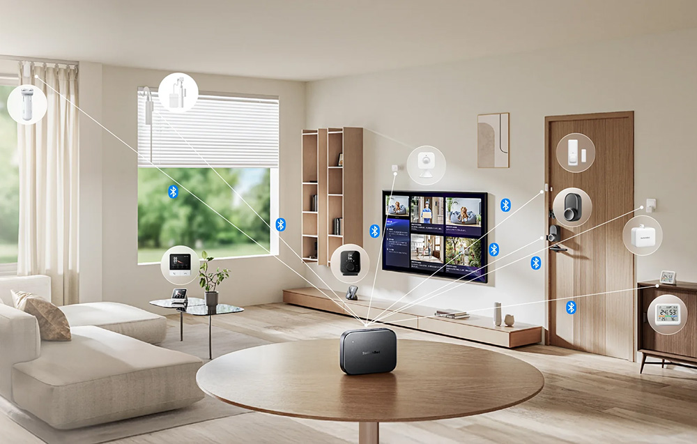 A living room with a TV and various smart home devices graphically connected to the SwitchBot gateway standing on the table.
