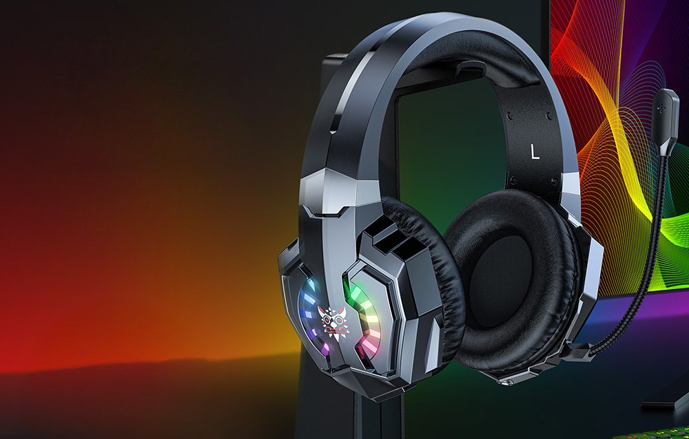 Black in-ear headphones hanging from a holder on a rainbow background