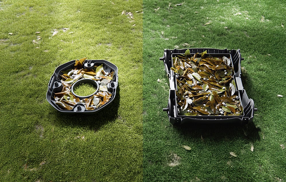Two trash bins lie on the lawn, filled with wet leaves and debris collected from the pool