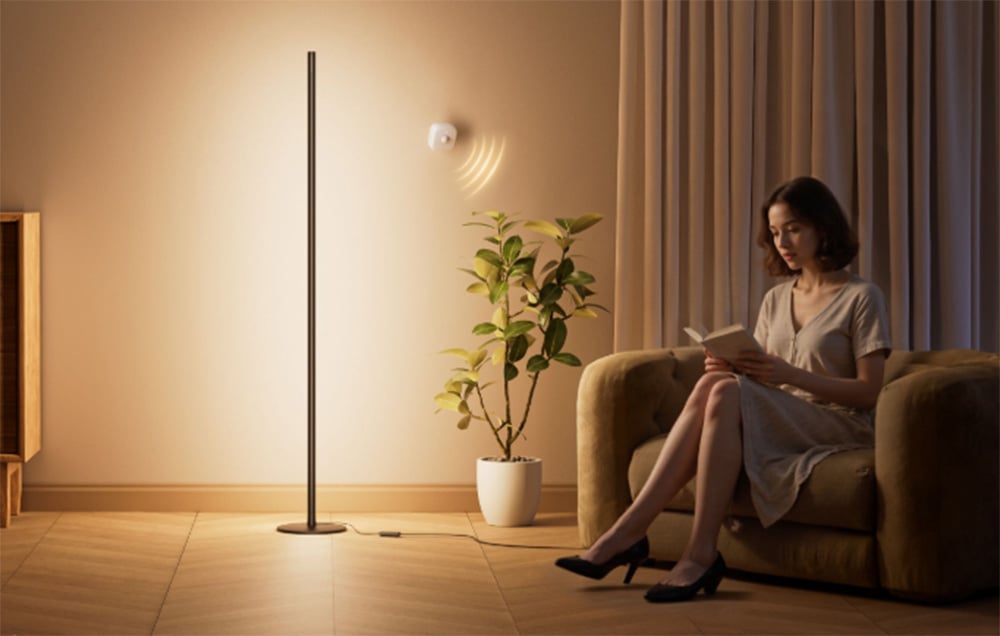 A presence sensor automatically turning on a mood lamp standing next to an armchair.