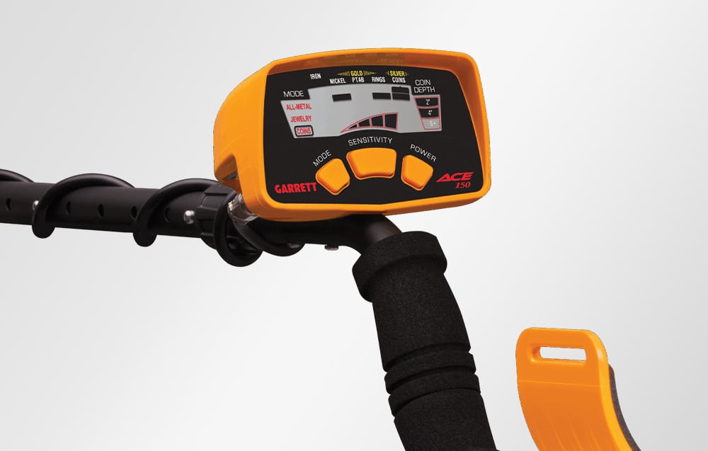 The control panel of the Garrett ACE 150 metal detector with the buttons and handle visible.