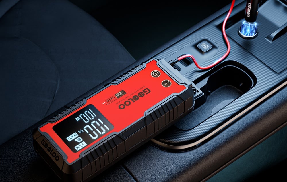 Car jump starter connected by cable to a socket in the car