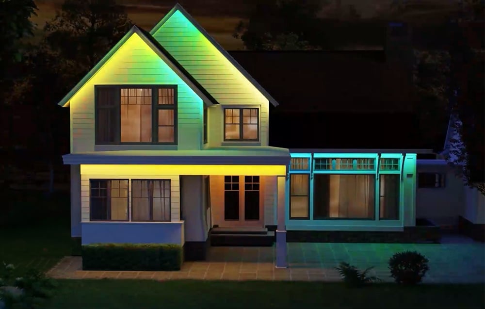 A modern house illuminated with yellow-green lights.
