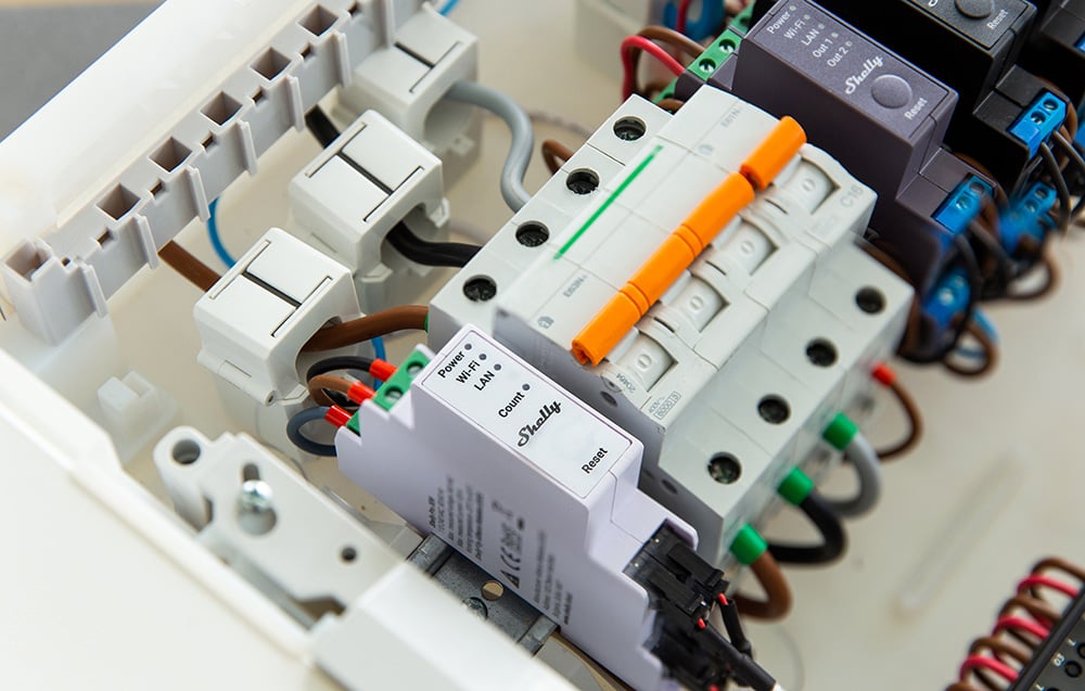 Electrical panel components, including the Shelly Pro smart relay, circuit breakers, and wiring.