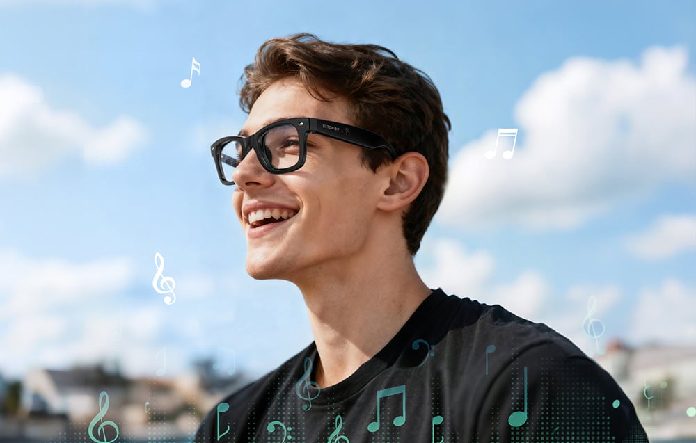 A smiling man wearing glasses and a black T-shirt, surrounded by colorful musical note icons
