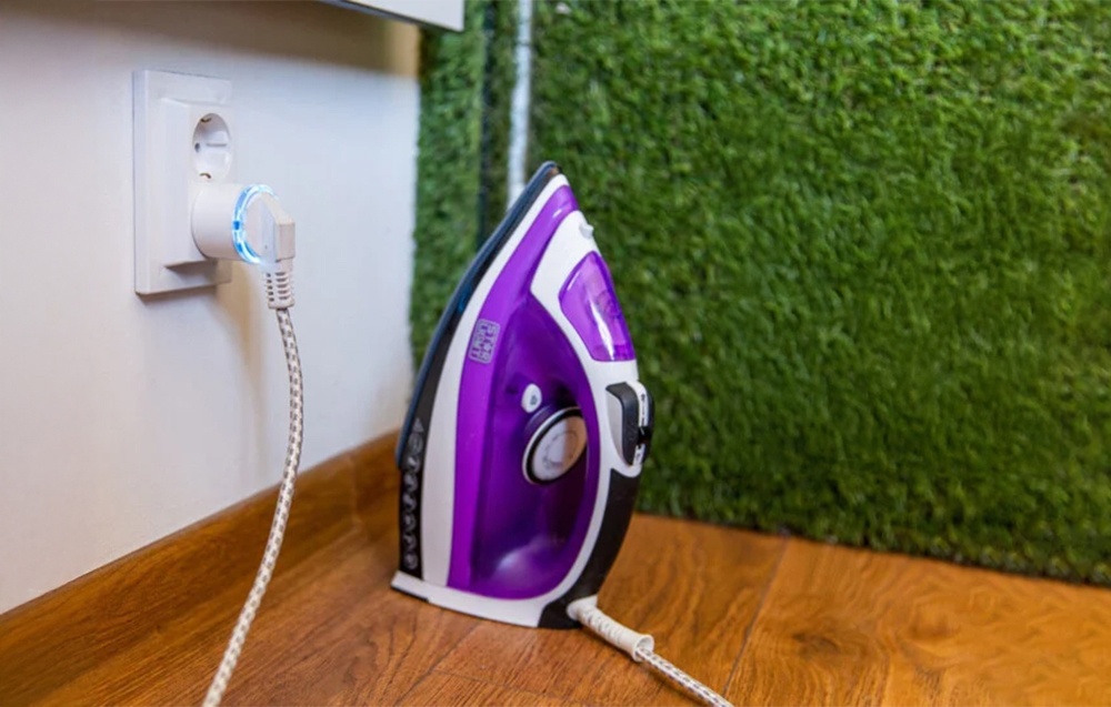 Shelly Plug S with blue illumination connected to an iron by an artificial grass wall