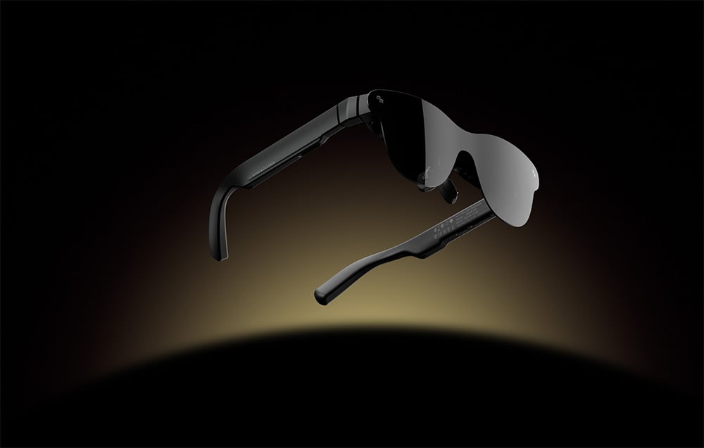 Sunglasses with dark lenses floating against a dark light gradient background